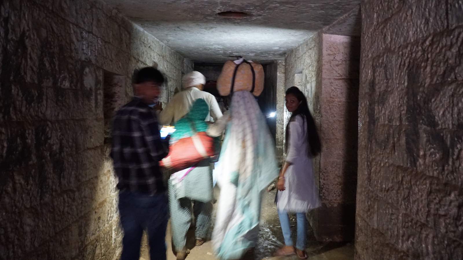 A totally random group of people: an old man, 2 old ladies, and 2 siblings noticed the tunnel too and decided to explore it. I thought well if they're going in then I'm going too. We walked into the tunnel and got to an underground room, then something freaked out the people in front of me and we quickly left. I think it was bats.